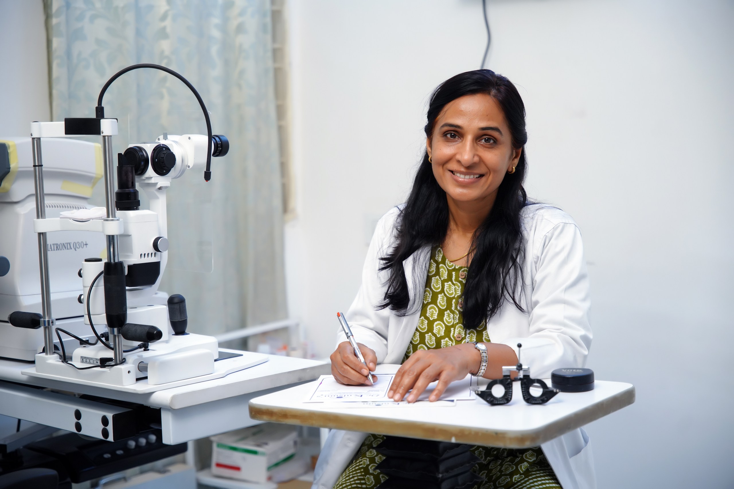 Dr. Kulsum Zaidi at the slit-lamp examination desk