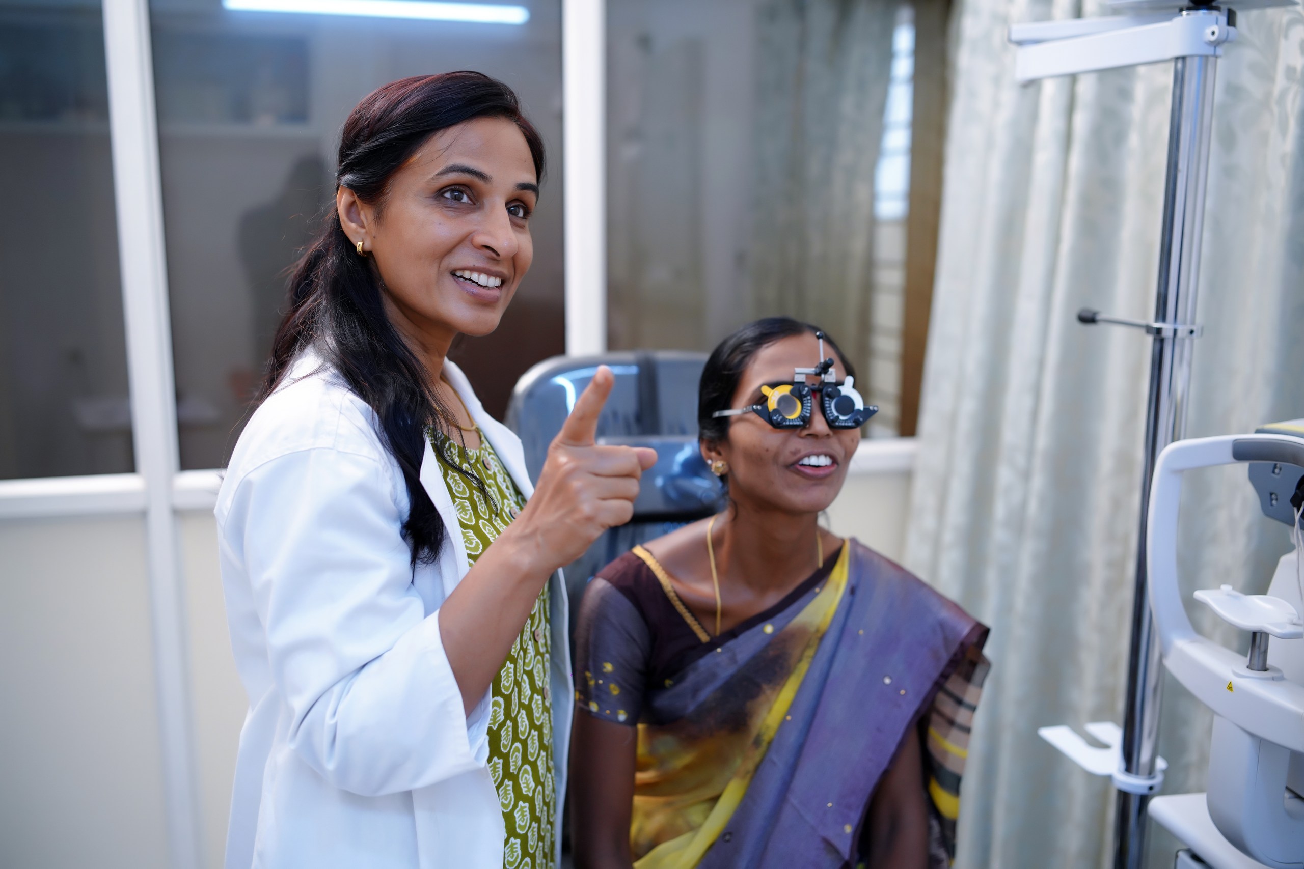 Dr. Kulsum Zaidi gently examining a patient's vision in the consultation room