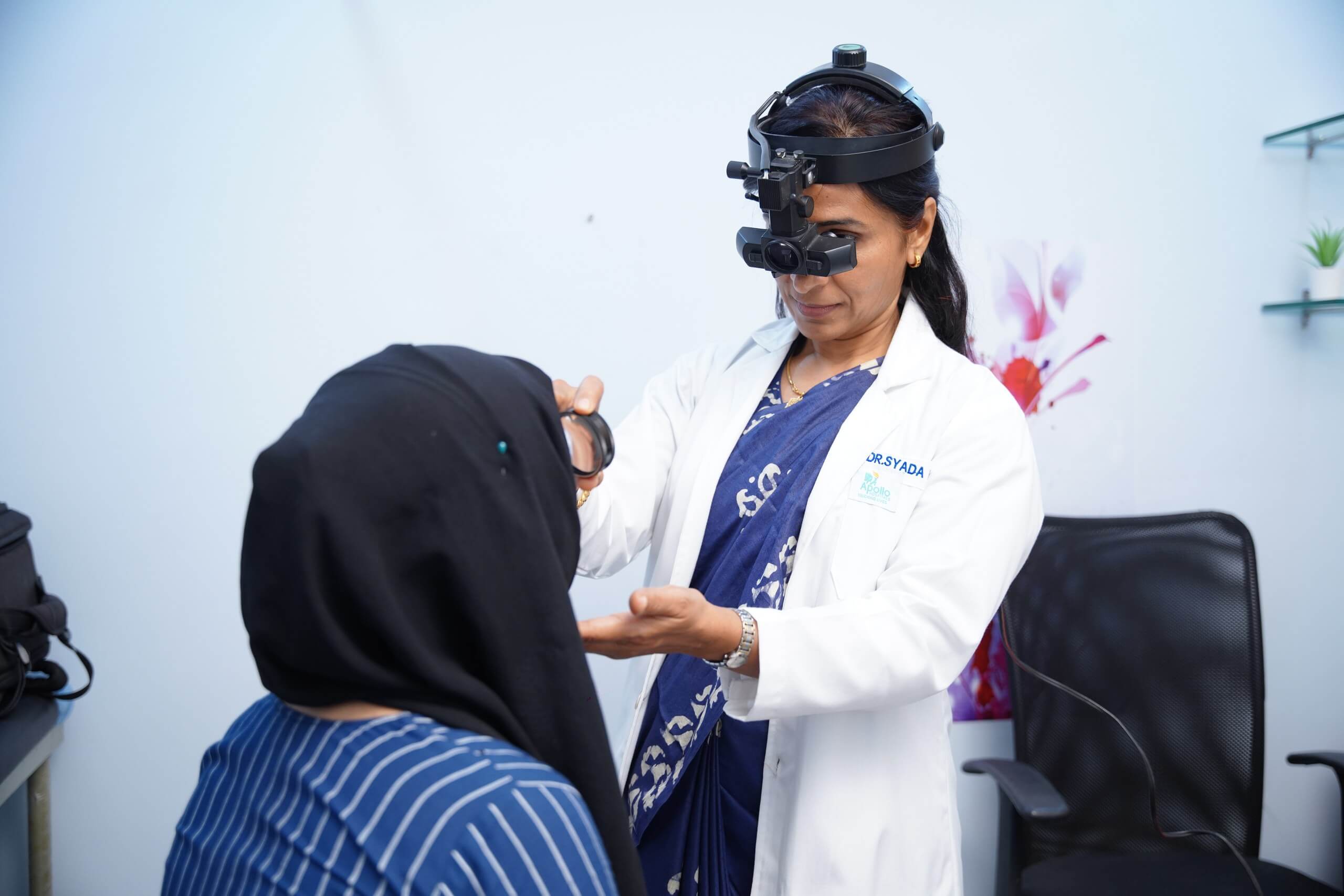 Dr. Kulsum performing a dilated retinal examination with an indirect ophthalmoscope